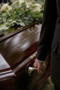 person carrying a casket at a funeral